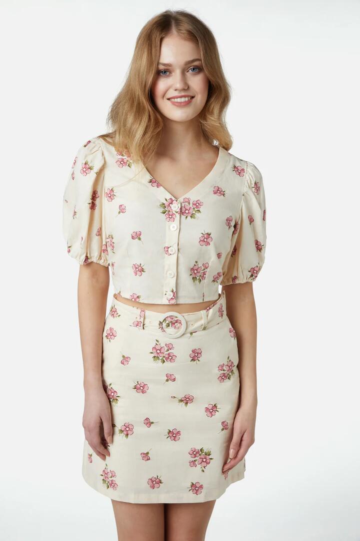 Image of a model wearing Skirts. Product name - Bianca Ditsy Skirt in Cream colour by brand - Princess Highway