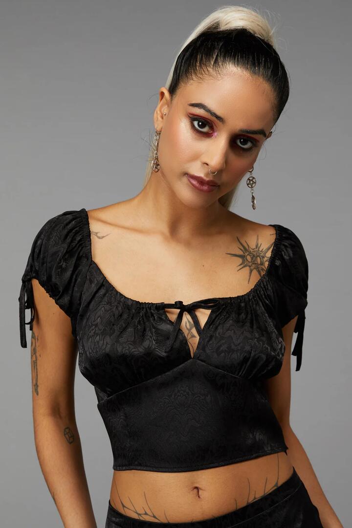 Image of a model wearing Tops. Product name - Nouveau Top in Red colour by brand - Black Friday