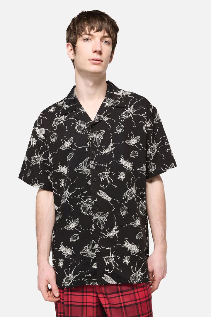 Image of a model wearing Tops. Productname: Dark Pieridae Short Sleeve Shirt in Black colour by brand - Dangerfield