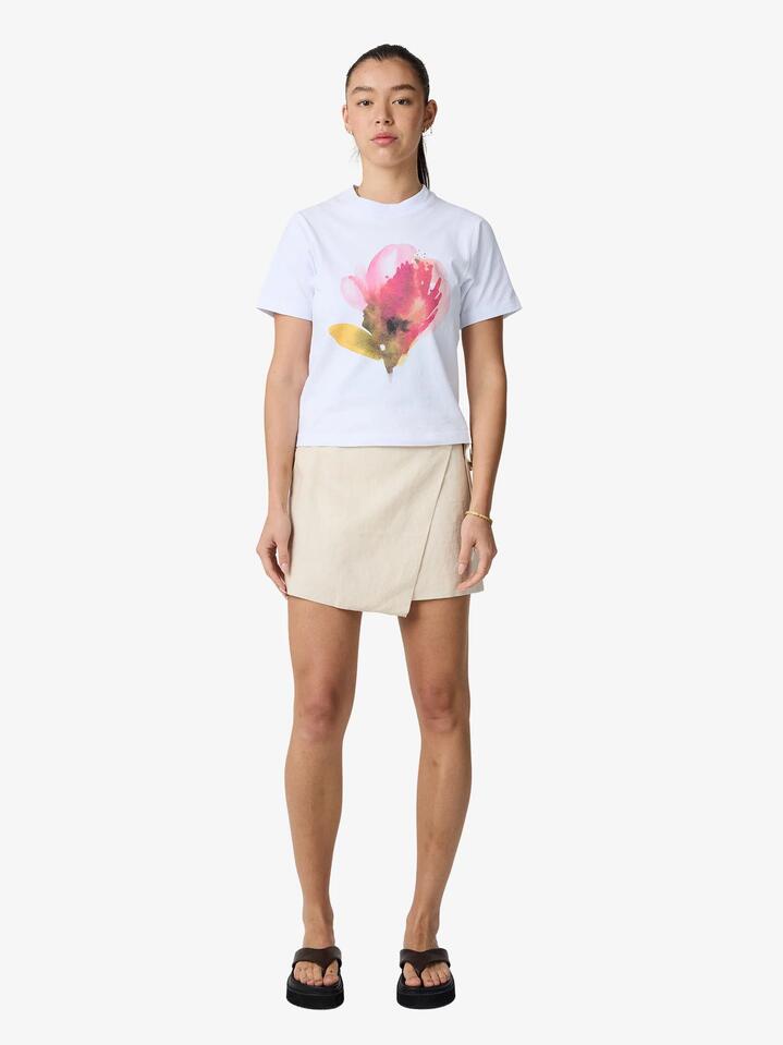 Image of a model wearing Skirts. Productname: Lulu & Rose Camille Wrap Mini Skirt in Natural colour by brand - Lulu & Rose