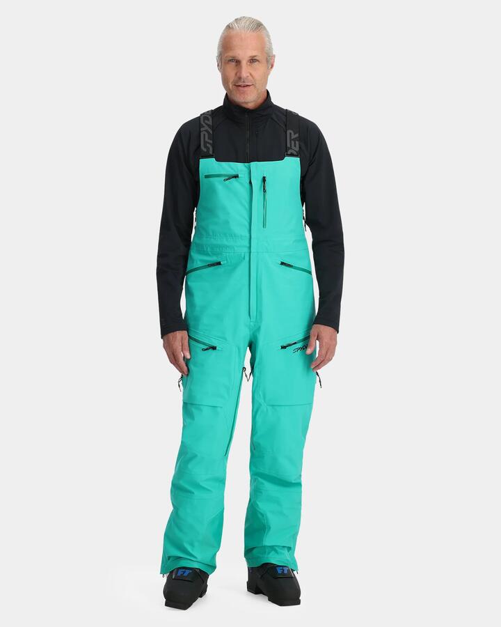 Image of a model wearing Pants. Product name - Spyder Mens Sanction Bib Shell Snow Pants Teal Green in Teal Green colour by brand - Spyder