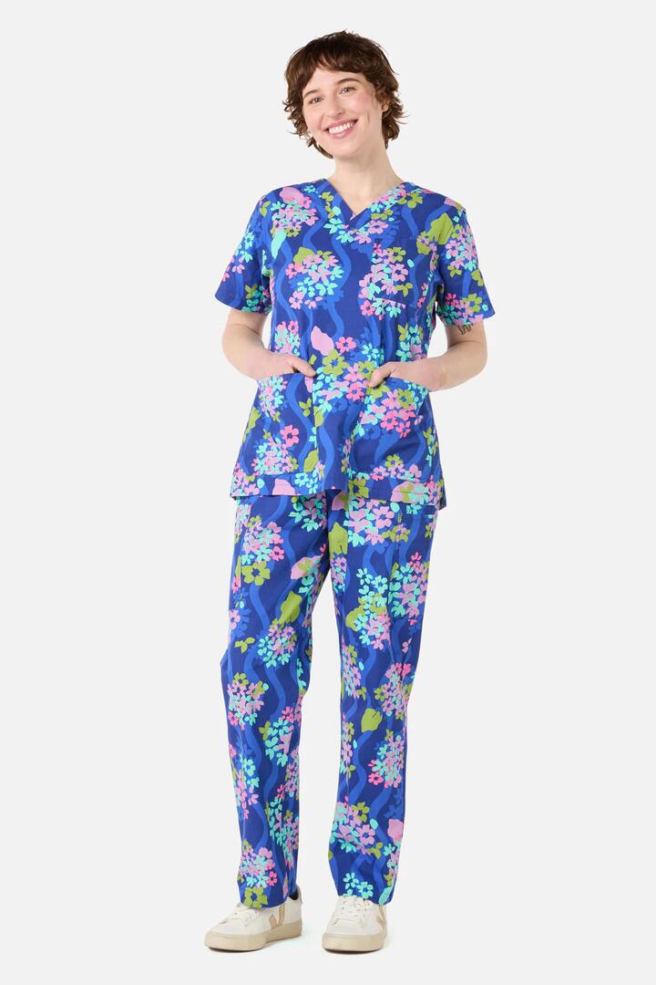 Image of a model wearing Uniforms & Workwear. Product name - Blue Blooms Scrub Set in Blue colour by brand - Gorman