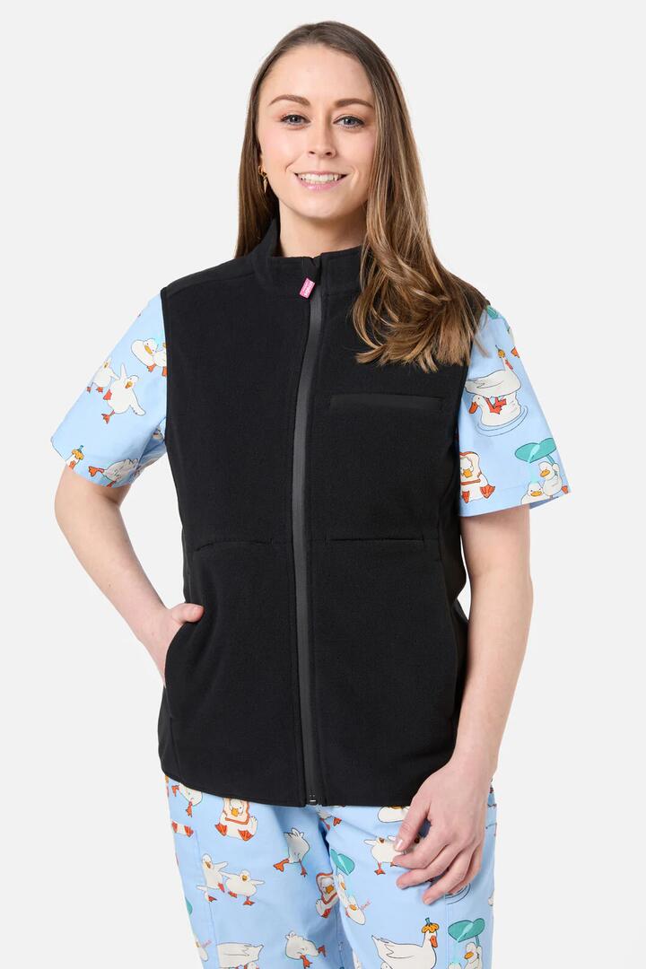 Image of a model wearing Outerwear. Product name - Black Polar Fleece Scrub Vest in Black colour by brand - Scrubs With Love