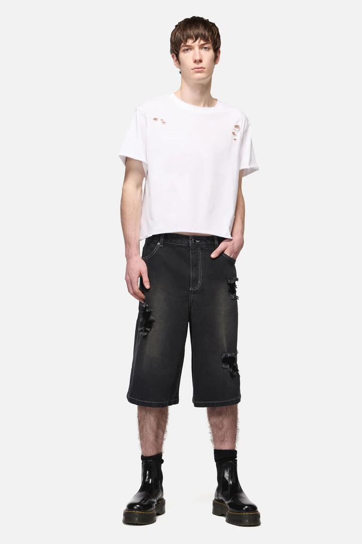 Image of a model wearing Pants. Productname: Denim Distressed Unisex Wide Leg Jorts in Black colour by brand - Dangerfield
