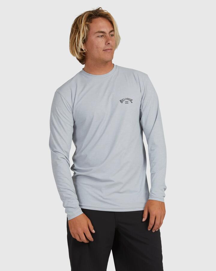 Image of a model wearing Tops. Product name - Billabong Mens Shoreline Loose Fit Long Sleeve Rashguard Light Grey Heather in Light Grey Heather colour by brand - Billabong
