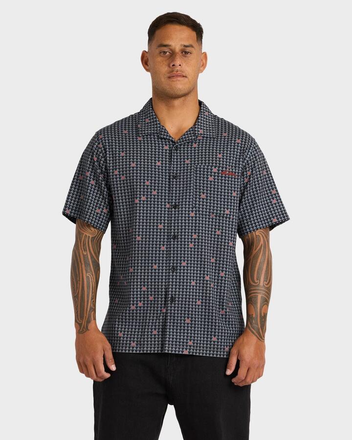 Image of a model wearing Tops. Product name - Quiksilver Mens Kehu Woven Short Sleeve Shirt Black in Black colour by brand - Quiksilver