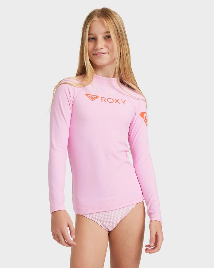 Image of a model wearing Tops. Product name - Roxy Girls 8-16 Heater Long Sleeve Rash Vest Bonbon in Bonbon colour by brand - Roxy