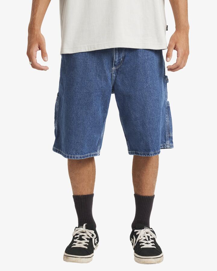 Image of a model wearing Shorts. Product name - Billabong Mens Bad Dog Workwear Denim Shorts Ocean Wash in Ocean Wash colour by brand - Billabong