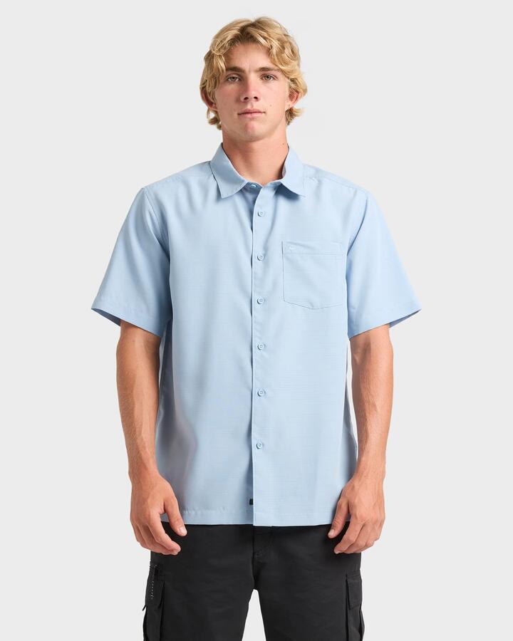 Image of a model wearing Tops. Product name - Quiksilver Mens Centinela 4 Short Sleeve Shirt Ashley Blue in Ashley Blue colour by brand - Quiksilver
