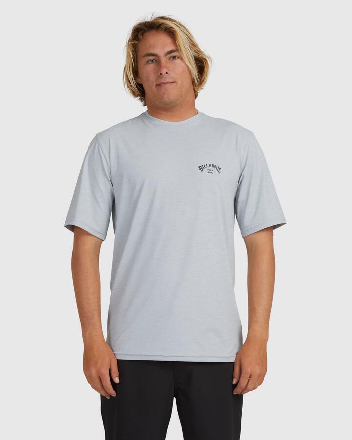 Image of a model wearing Tops. Product name - Billabong Mens Shoreline Loose Fit Short Sleeve Rash Vest Light Grey Heather in Light Grey Heather colour by brand - Billabong