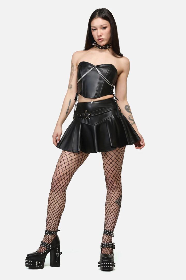 Image of a model wearing Skirts. Productname: Roxi Star Buckle Grunge Skort in Black colour by brand - Dangerfield