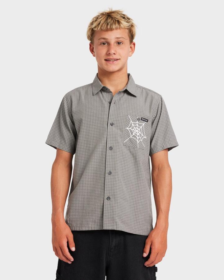 Image of a model wearing Tops. Product name - Billabong Boys 8-16 Mogul Short Sleeve Shirt Raven in Raven colour by brand - Billabong