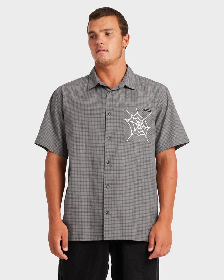 Image of a model wearing Tops. Product name - Billabong Mens Web Mogul Short Sleeve Shirt Raven in Raven colour by brand - Billabong