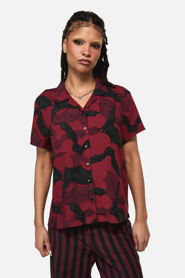 Image of a model wearing Tops. Product name - Batz Goth Short Sleeve Blouse in Red colour by brand - Black Friday