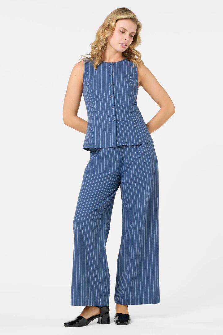 Image of a model wearing Pants. Productname: Frankie Pinstripe Pant in Navy colour by brand - Princess Highway