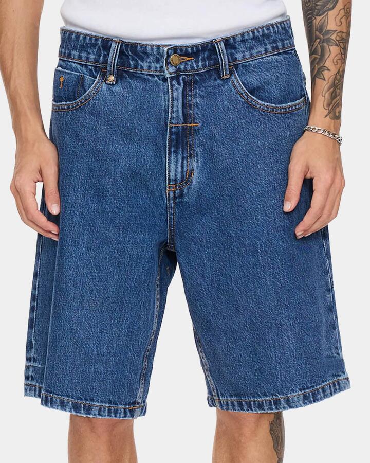 Image of a model wearing Shorts. Productname: thrills Mens Mid Slacker Relaxed Long Denim Shorts Deep Vintage Blue - in Deep Vintage Blue colour by brand - Thrills