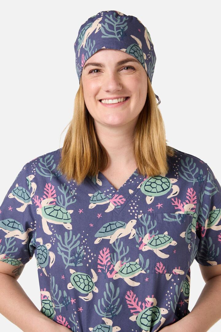 Image of a model wearing Tops. Productname: Sea Turtle Scrub Hat in Blue colour by brand - Scrubs With Love