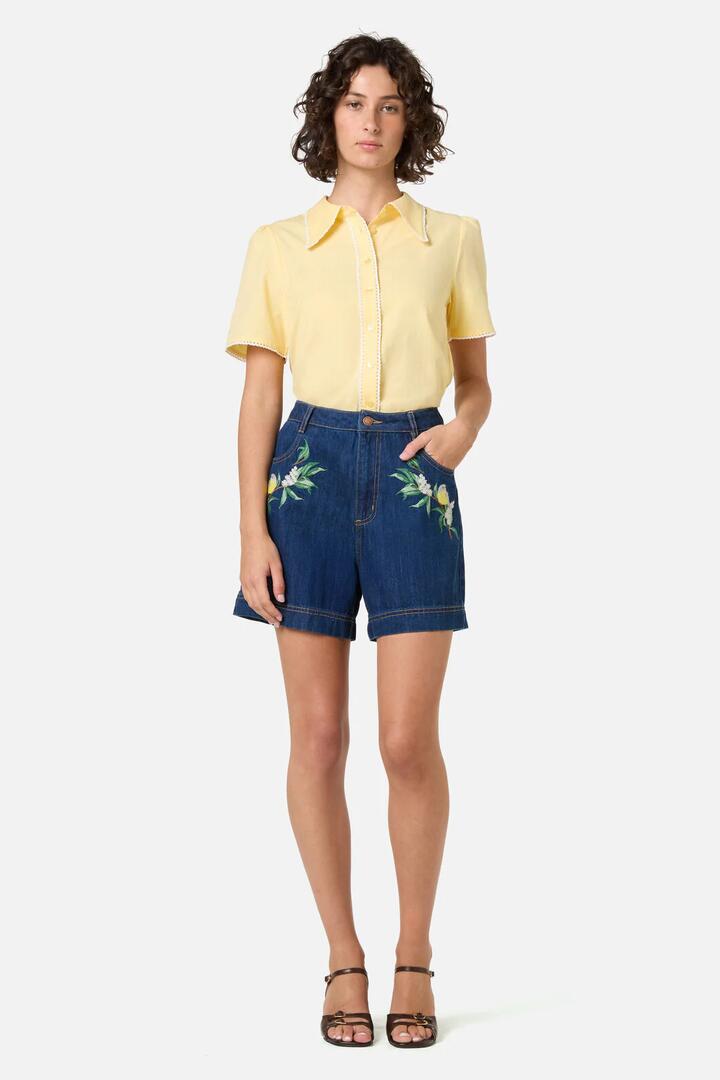Image of a model wearing Shorts. Product name - Robin Embroidered Denim Short in Blue Denim colour by brand - Princess Highway