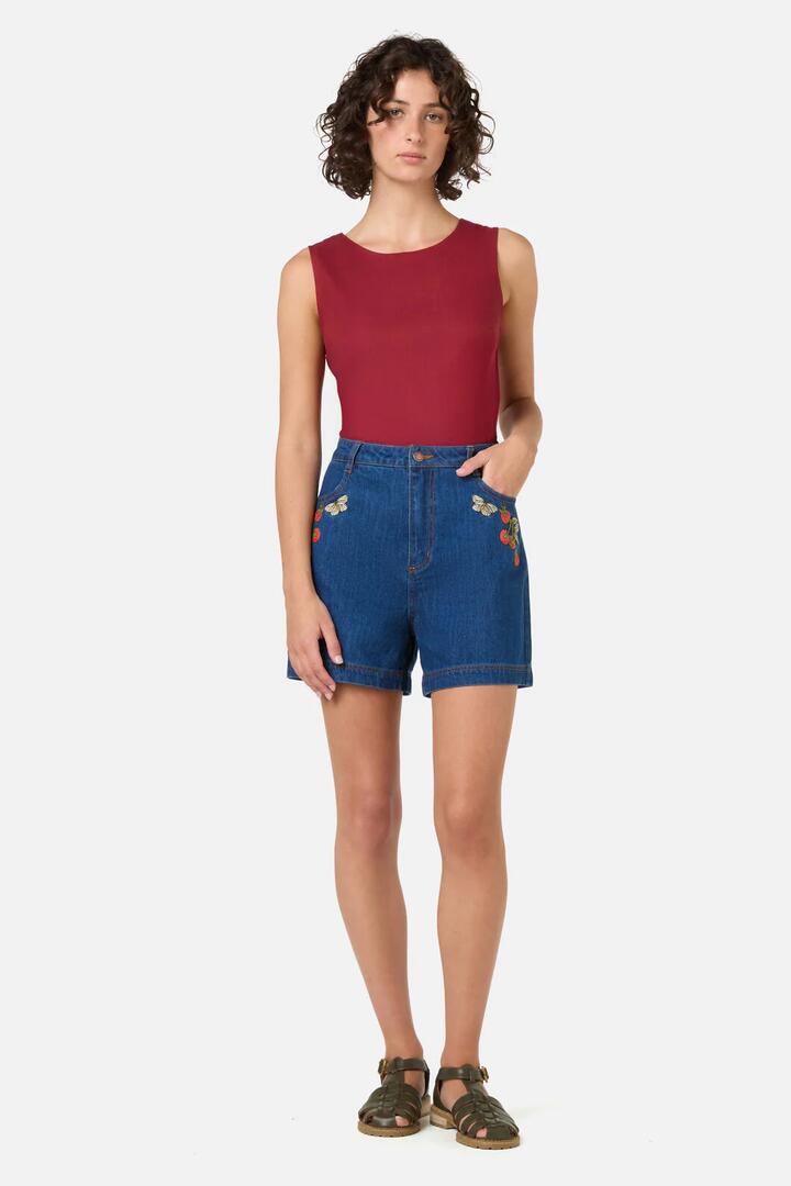 Image of a model wearing Shorts. Product name - Tomatoes Embroidered Short in Blue Denim colour by brand - Princess Highway
