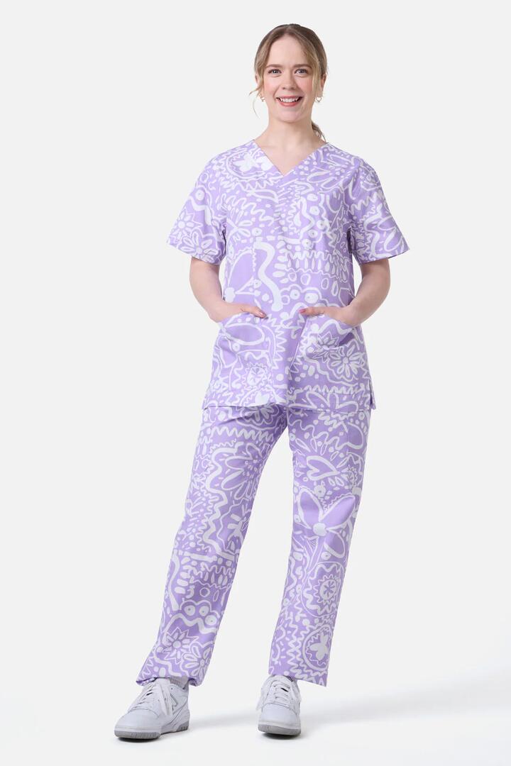 Image of a model wearing Uniforms & Workwear. Product name - Daisy Mae Scrub Set in Lilac colour by brand - Gorman