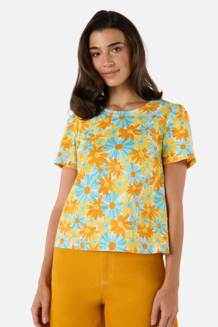 Image of a model wearing Tops. Productname: Vintage Daisy Short Sleeve Top in Blue colour by brand - Princess Highway