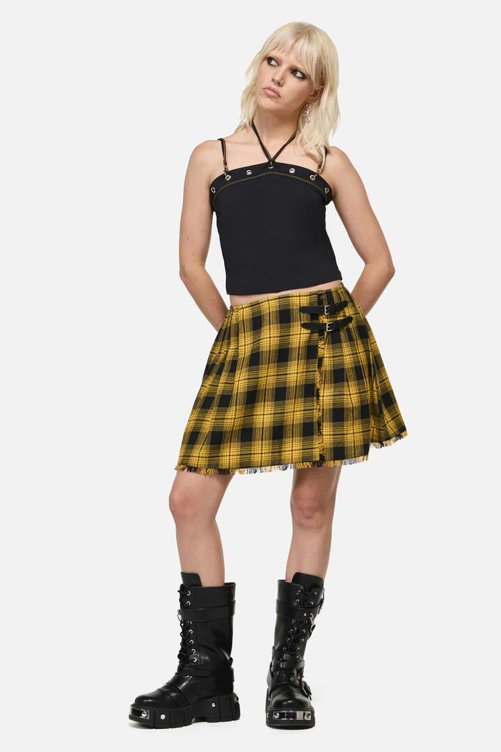 Image of a model wearing Skirts. Product name - Tai Tartan Punk Mini Skirt in Yellow colour by brand - Dangerfield