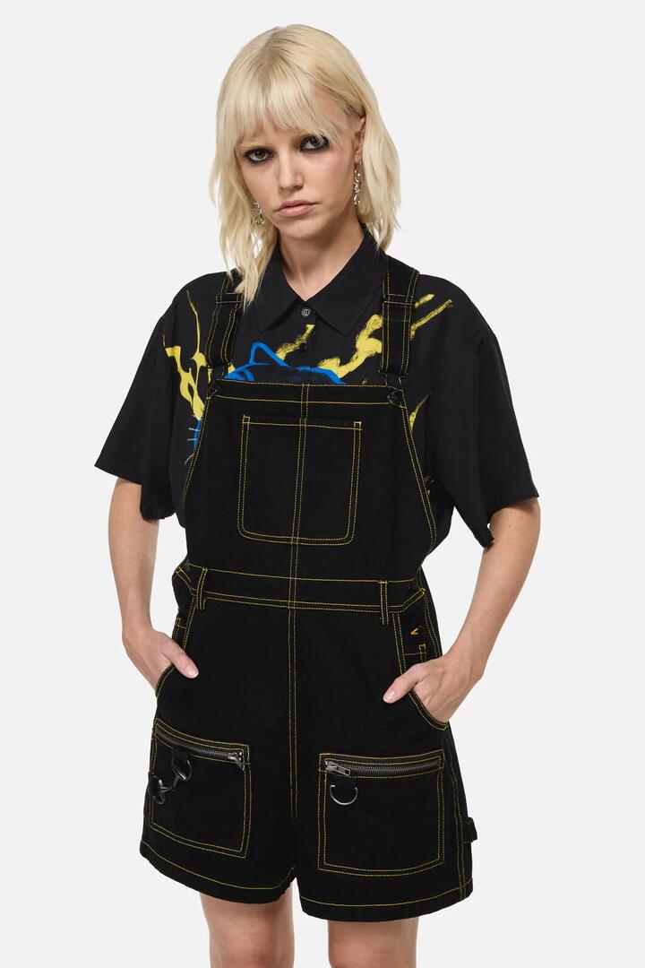 Image of a model wearing Pants. Product name - Electric Punk Trim Overall in Black colour by brand - Dangerfield