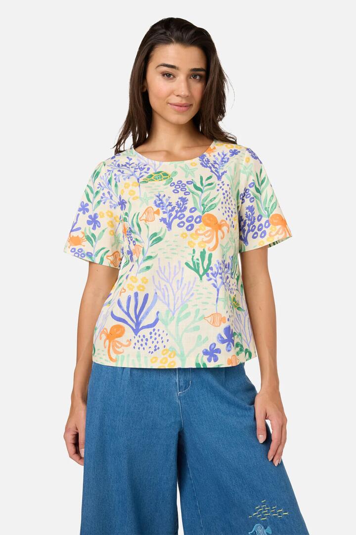 Image of a model wearing Tops. Productname: Coral Reef Short Sleeve Top in Cream colour by brand - Princess Highway
