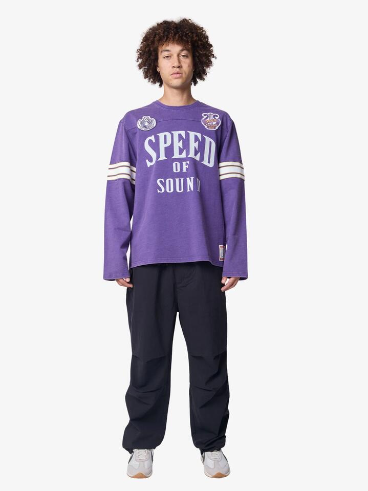 Image of a model wearing Tops. Productname: Deus Eight Track Jersey in Violet Indigo colour by brand - Deus