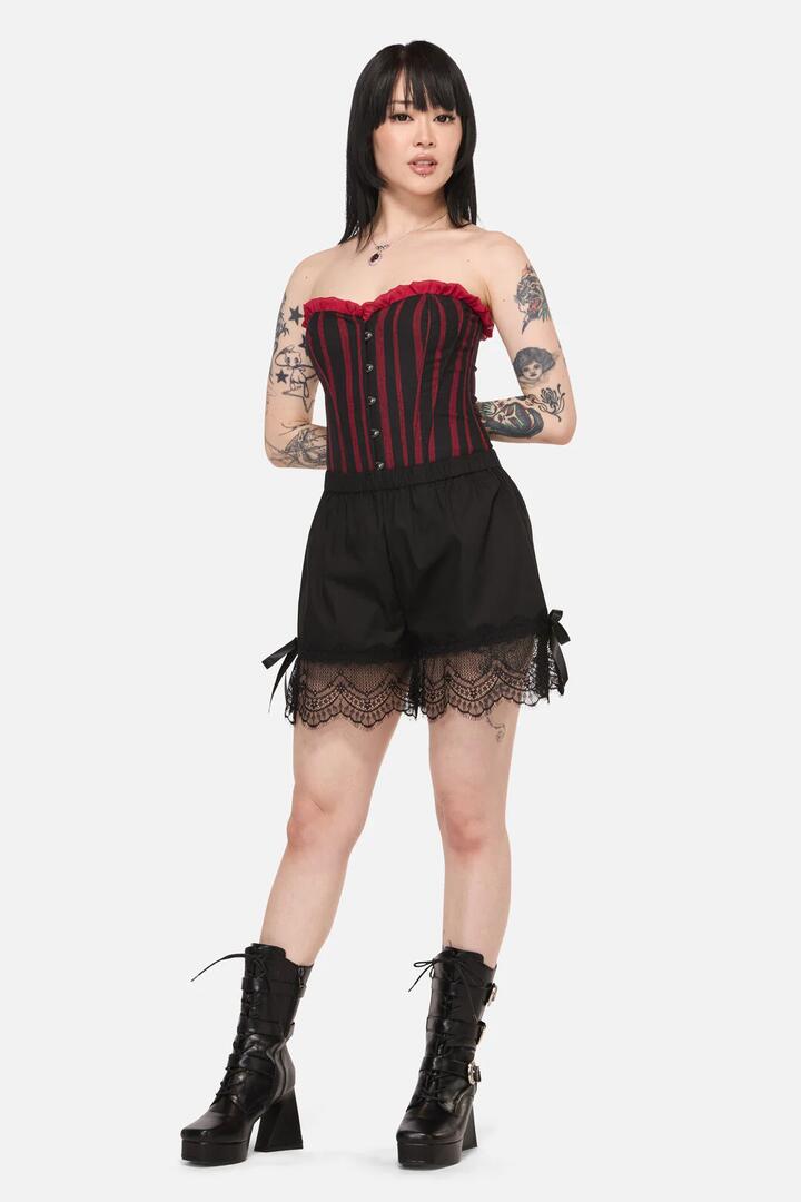 Image of a model wearing Shorts. Product name - Tabitha Goth Bloomer Short in Black colour by brand - Black Friday