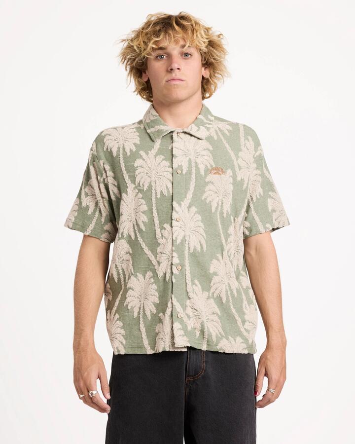 Image of a model wearing Tops. Productname: rvca Mens Palm Fall Short Sleeve Shirt Jade - in Jade colour by brand - Rvca