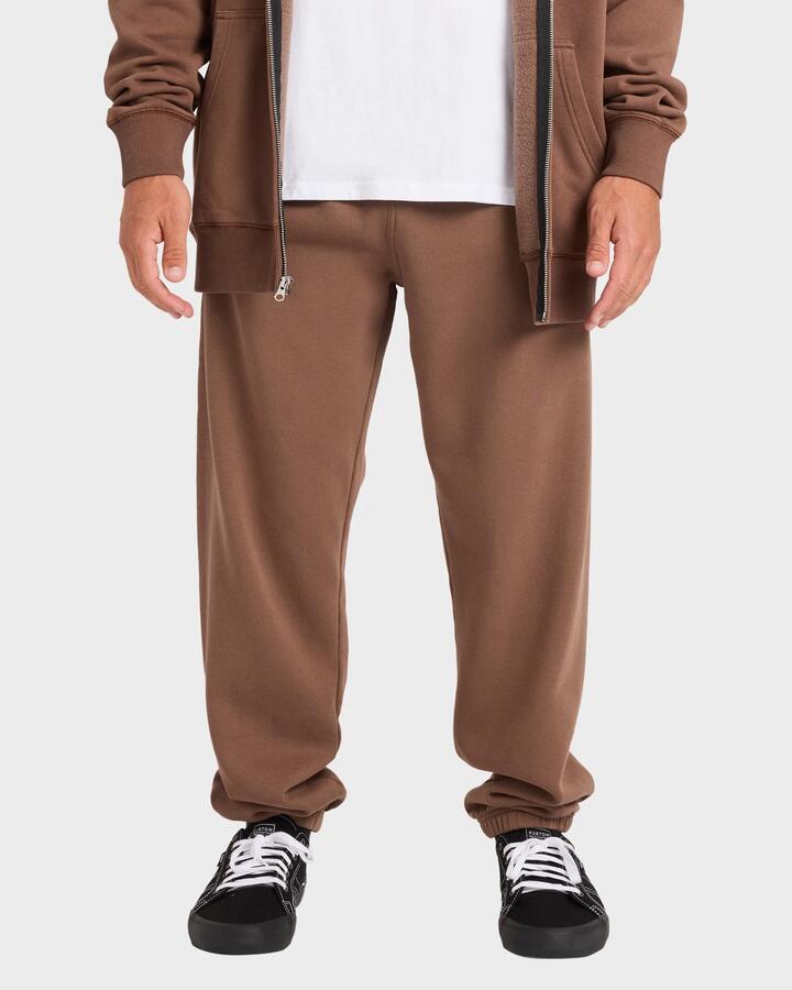 Image of a model wearing Pants. Product name - Billabong Mens Premium Wave Wash Trackpants Mocha in Mocha colour by brand - Billabong