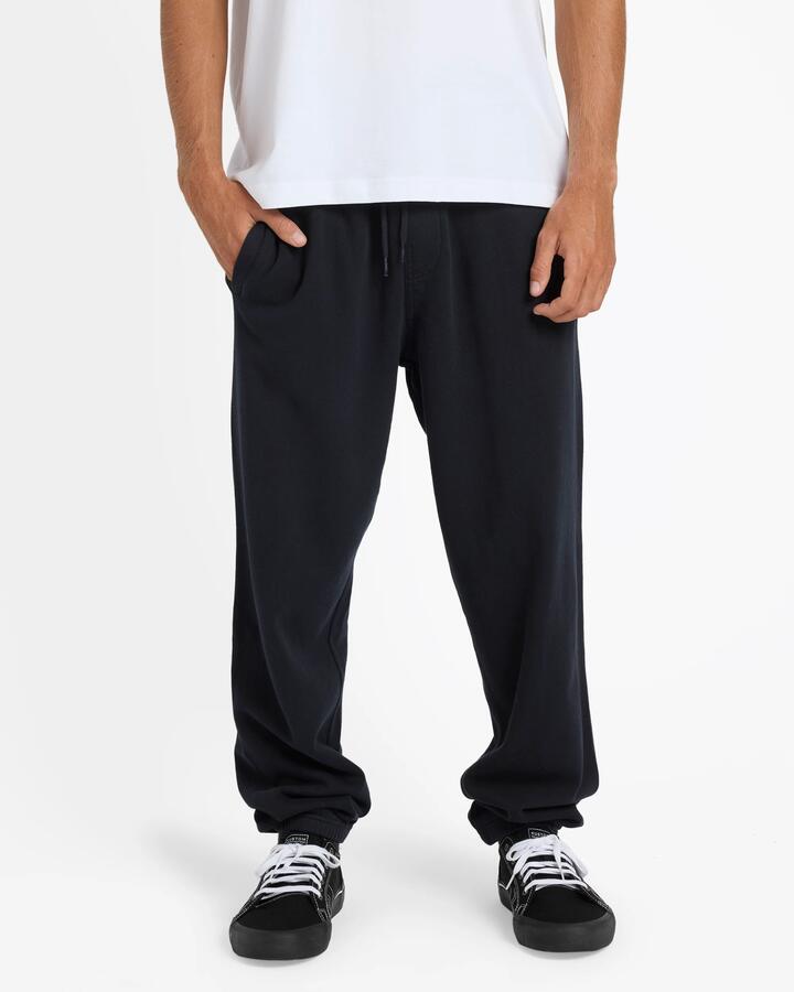 Image of a model wearing Pants. Productname: Billabong Mens Premium Wave Wash Trackpants Black - in Black colour by brand - Billabong