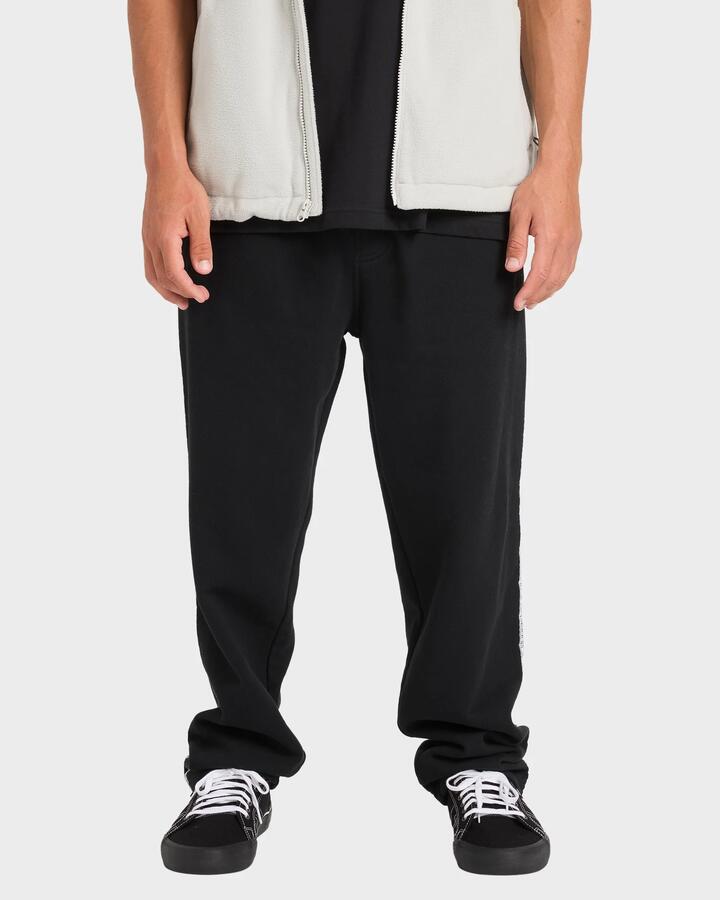 Image of a model wearing Pants. Product name - Billabong Mens Spec 73 Trackpants Black in Black colour by brand - Billabong