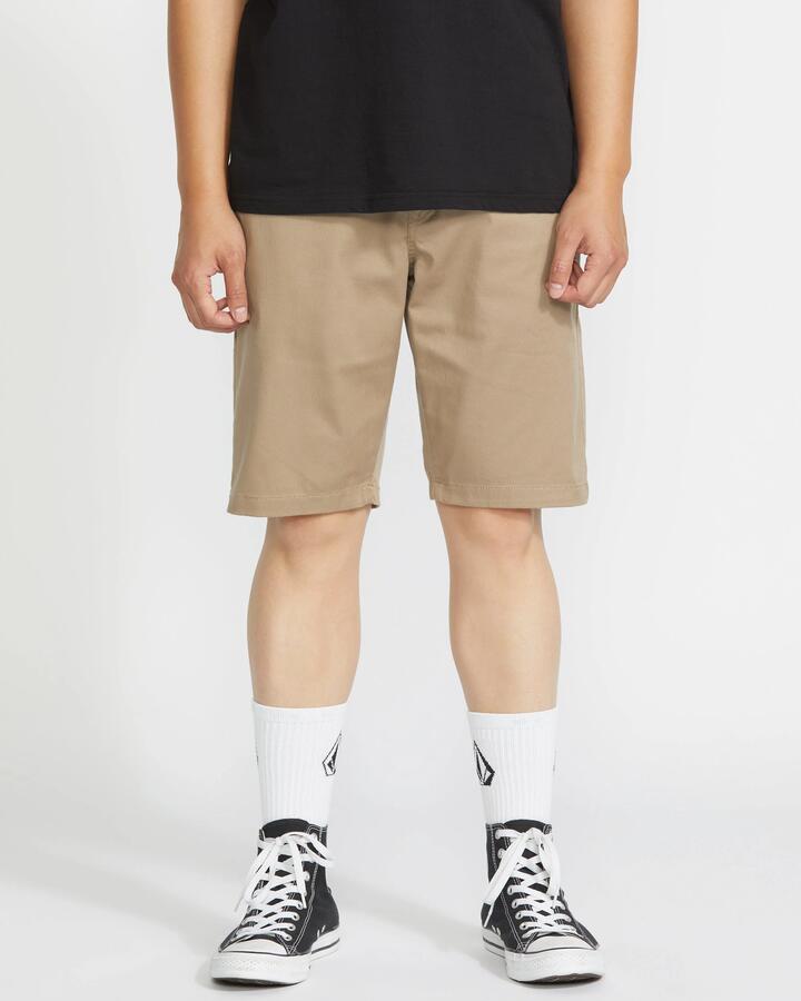 Image of a model wearing Pants. Product name - Volcom Mens Frickin Modern Stretch Chino Pants Khaki in Khaki colour by brand - Volcom