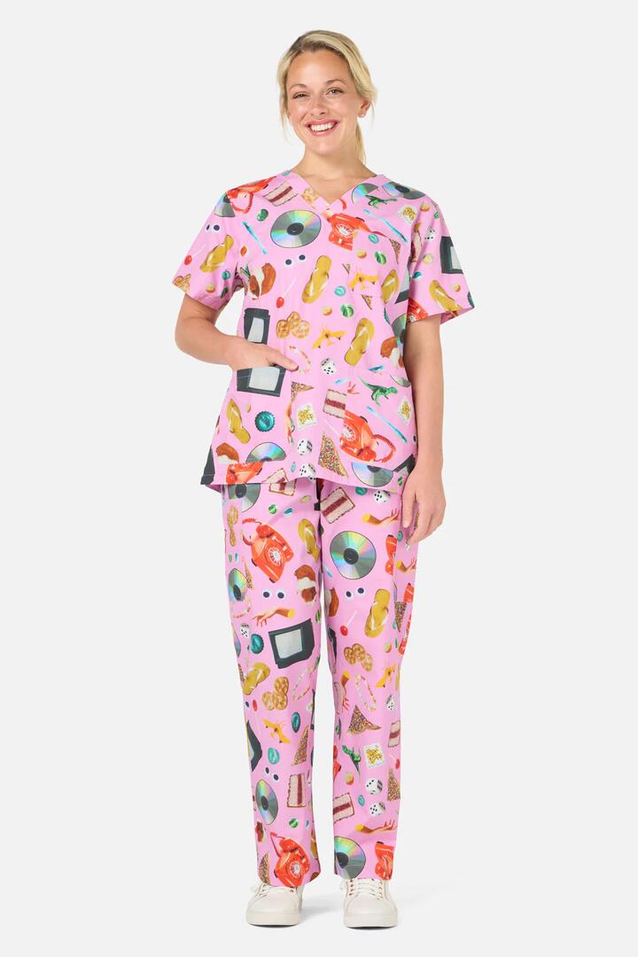 Image of a model wearing Uniforms & Workwear. Product name - Nostalgia Scrub set in Pink colour by brand - Scrubs With Love