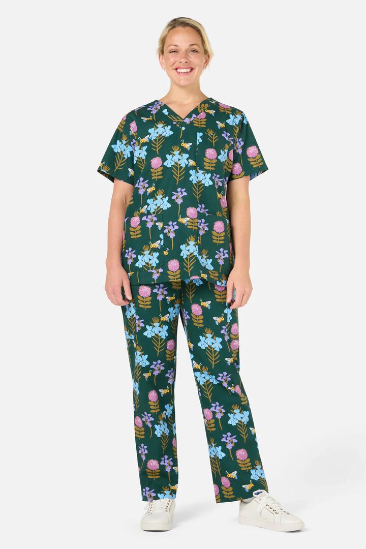 Image of a model wearing Uniforms & Workwear. Product name - Blue Banded Bee scrub set in Green colour by brand - Scrubs With Love