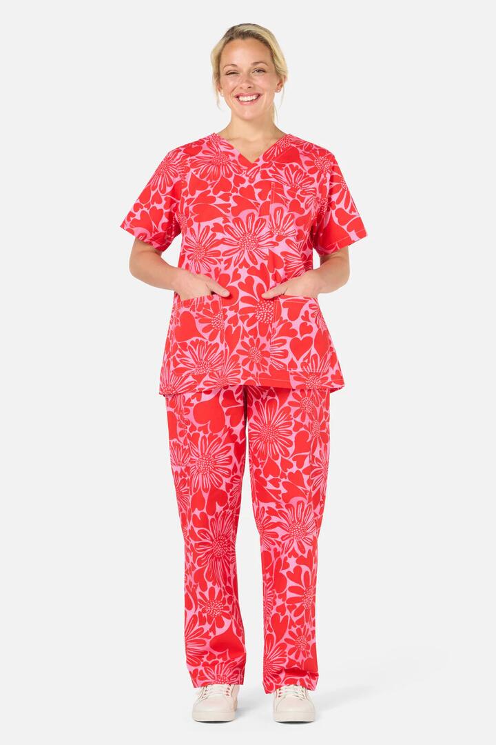 Image of a model wearing Uniforms & Workwear. Product name - Painted Love scrub set in Red colour by brand - Gorman
