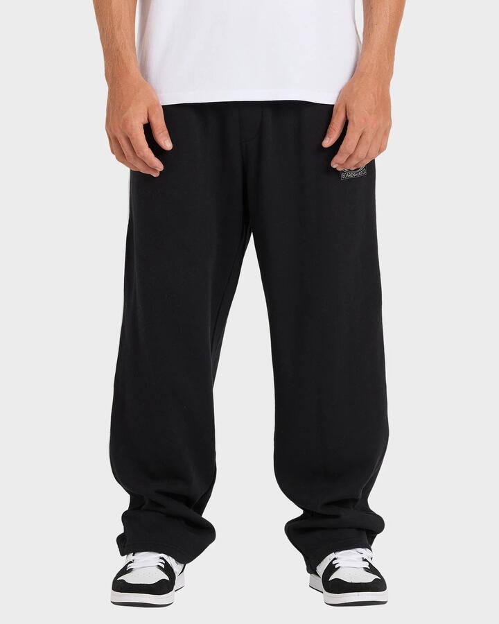 Image of a model wearing Pants. Product name - Quiksilver Mens Interconnect Track Pants Black in Black colour by brand - Quiksilver