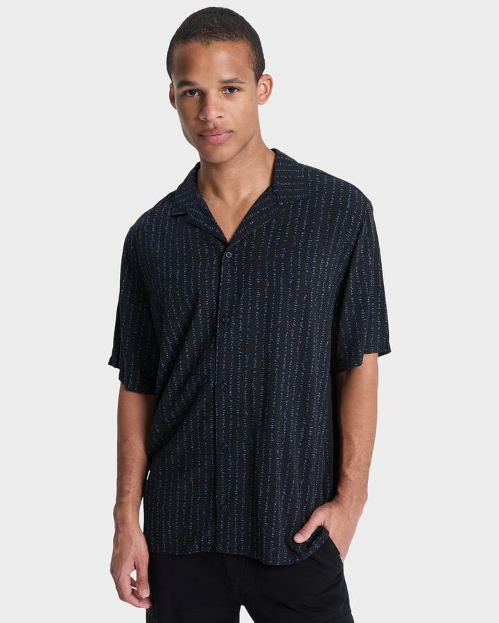 Image of a model wearing Tops. Product name - Quiksilver Mens Safe Paradise Short Sleeve Shirt Black Vertical Quik Thoughts in Black Vertical Quik Thoughts colour by brand - Quiksilver