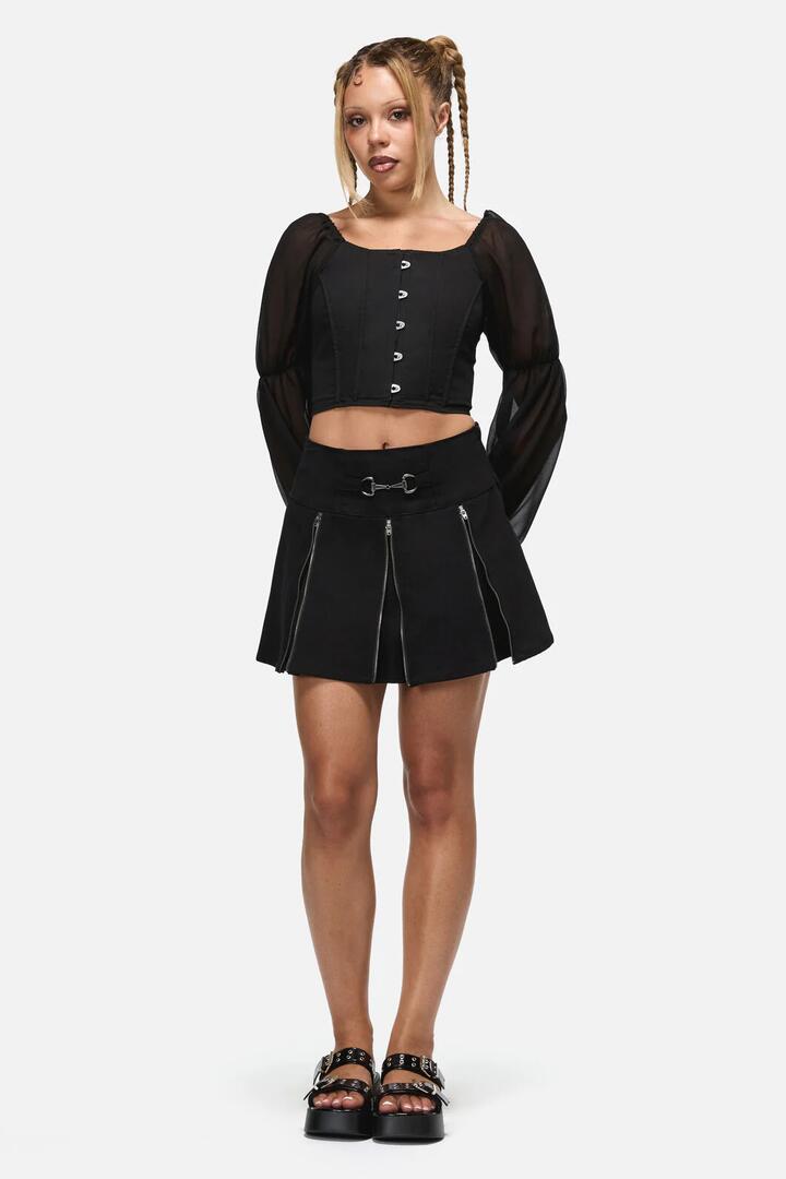 Image of a model wearing Skirts. Product name - Dystopia Goth Buckle Skort in Black colour by brand - Black Friday