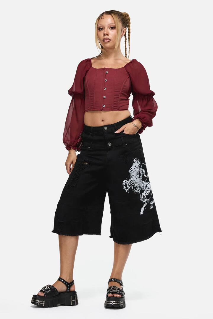 Image of a model wearing Shorts. Product name - Dystopia Goth Short in Black colour by brand - Black Friday