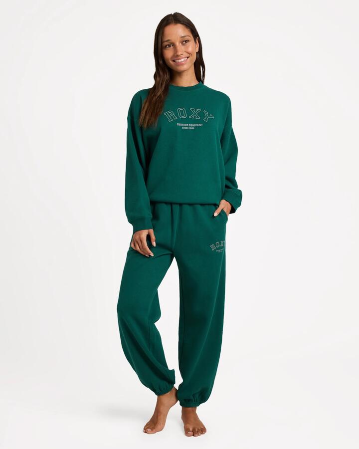 Image of a model wearing Pants. Product name - Roxy Womens Dreamy Days Trackpants Forest in Forest colour by brand - Roxy