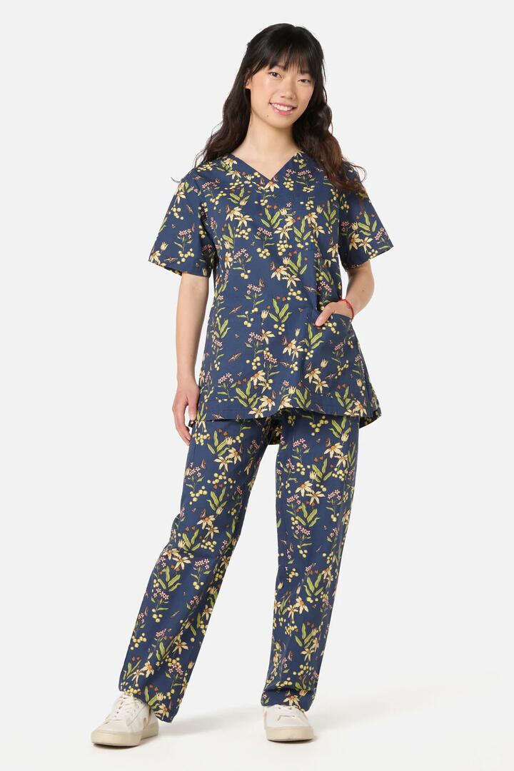 Image of a model wearing Uniforms & Workwear. Product name - Dreamy Native scrub set in Navy colour by brand - Scrubs With Love