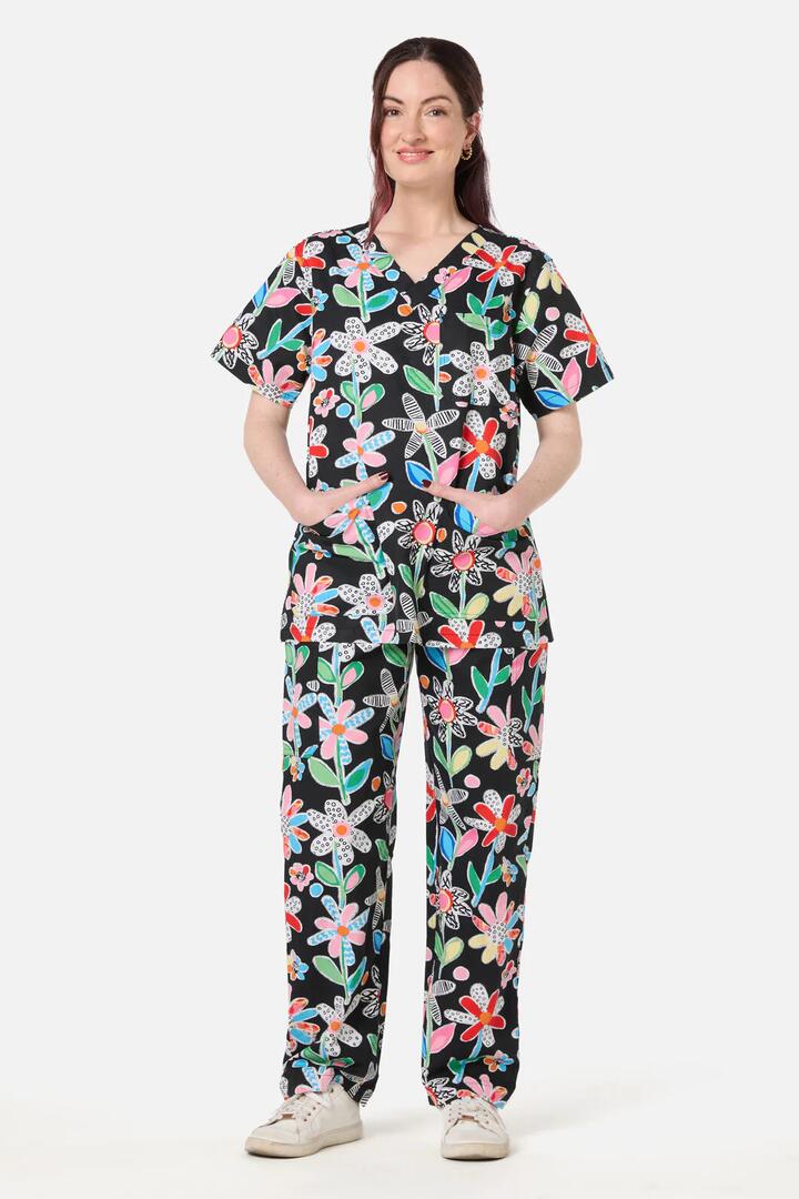 Image of a model wearing Uniforms & Workwear. Product name - Floral Play scrub set in Black colour by brand - Gorman