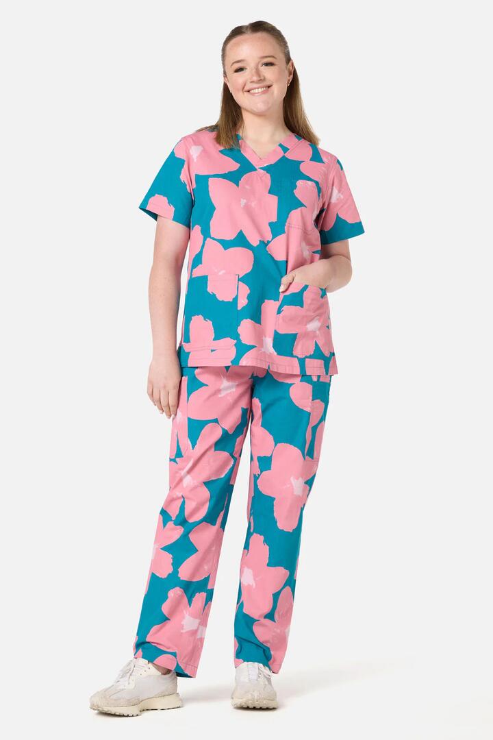 Image of a model wearing Uniforms & Workwear. Product name - Green Poppy scrub set in Green colour by brand - Gorman