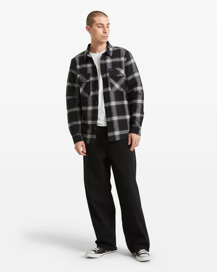 Image of a model wearing Tops. Product name - Volcom Mens Wilderstone Long Sleeve Shirt Black in Black colour by brand - Volcom