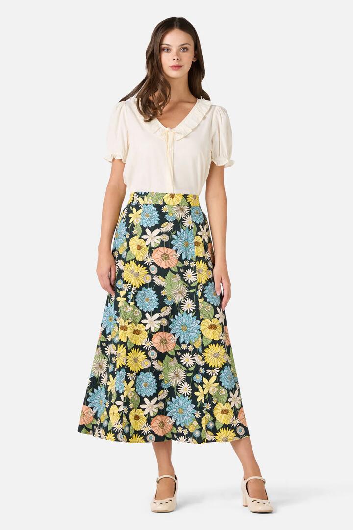 Image of a model wearing Skirts. Product name - Leonie Floral Midi Skirt in Deep Green colour by brand - Princess Highway