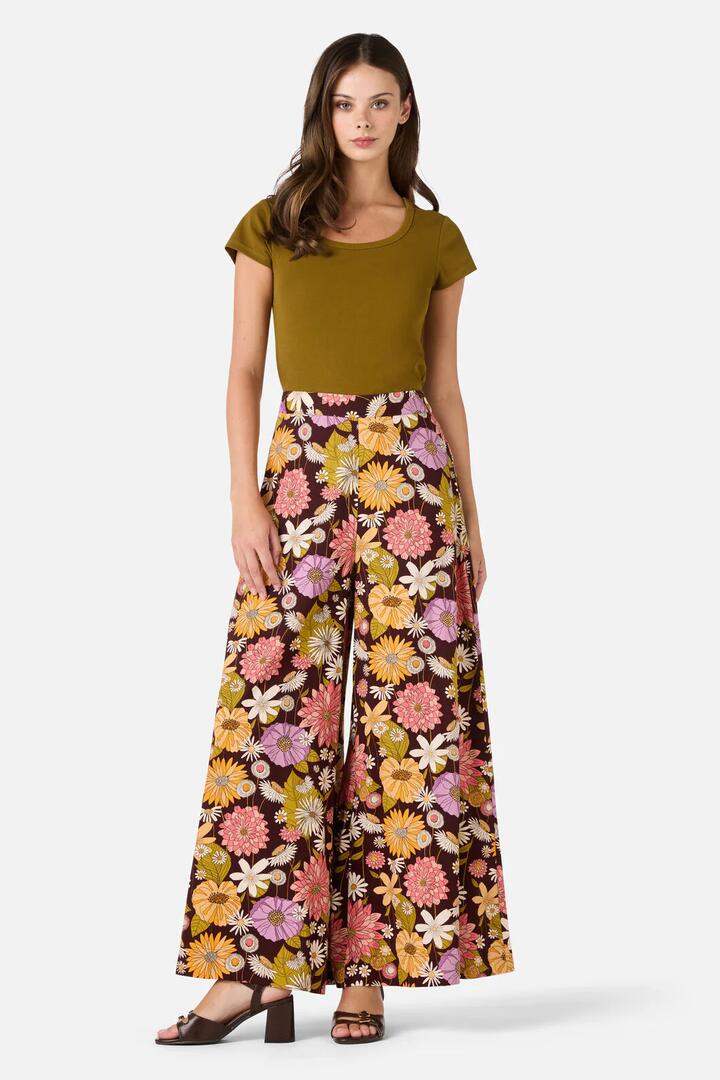Image of a model wearing Pants. Product name - Leonie Floral Pant in Plum colour by brand - Princess Highway