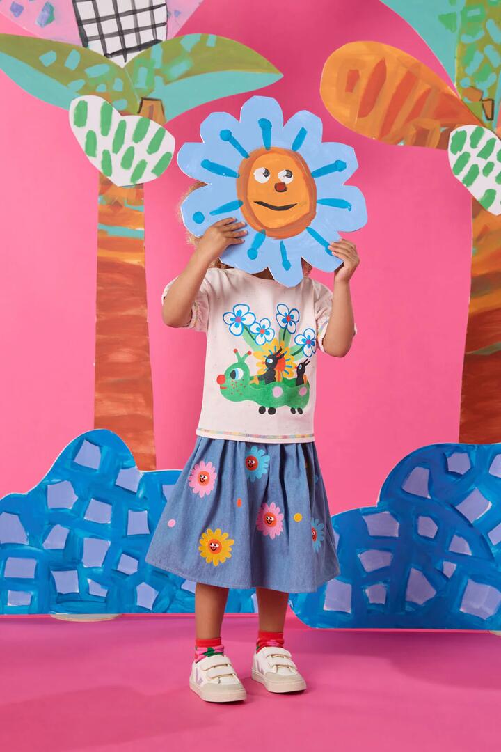 Image of a model wearing Skirts. Product name - Daisy Embroidery Kids Skirt in Denim colour by brand - Gorman